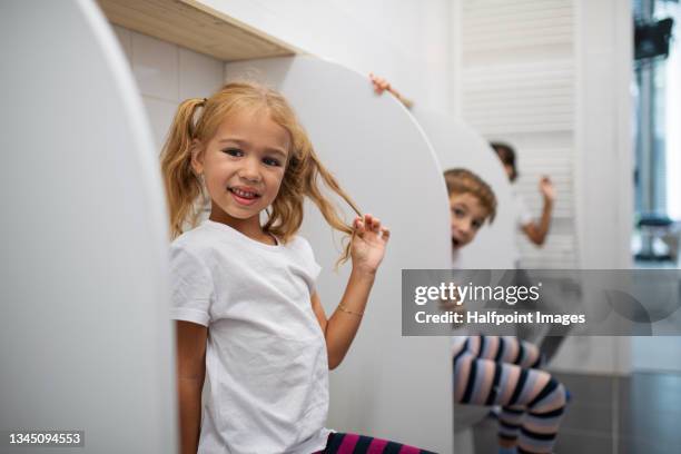 preschool children sitting on loo indoors at nursery bathroom. - weeshuis stockfoto's en -beelden