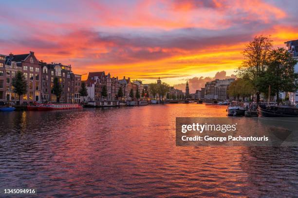 majestic sunset colors in amsterdam, holland - fluss amstel stock-fotos und bilder