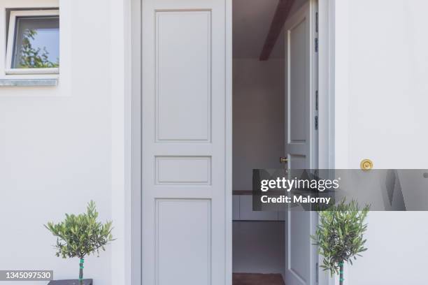 entrance to a villa. newly renovated home. - bavarian man in front of house stock-fotos und bilder