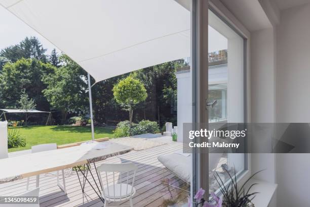 view outside a window into the garden and terrace. - veranda fotografías e imágenes de stock
