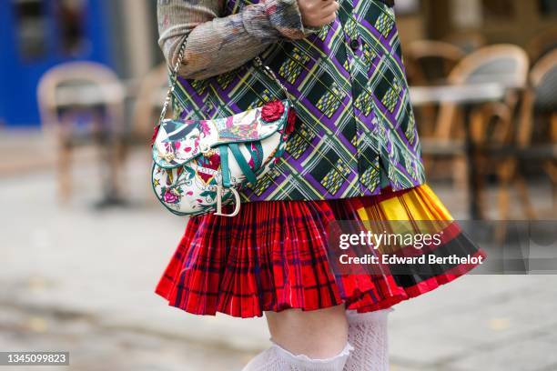 Guest wears a brown with pale pink / yellow / blue flower print pattern ribbed long sleeves t-shirt, a black with purple / green / white print...