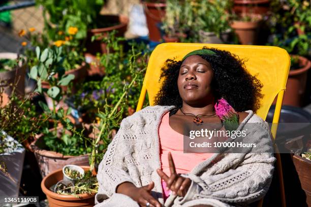 woman sleeping on yellow deck chair - sleeping woman stock pictures, royalty-free photos & images