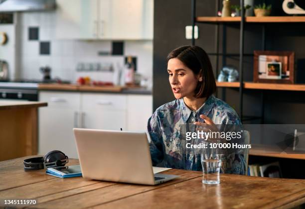 mid adult businesswoman working from home on laptop - woman portrait kitchen laptop stock-fotos und bilder