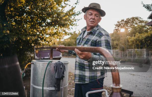 preparation of moonshine - cognac stockfoto's en -beelden