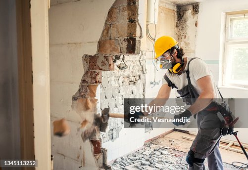 Worker using hammer Worker using hammer
