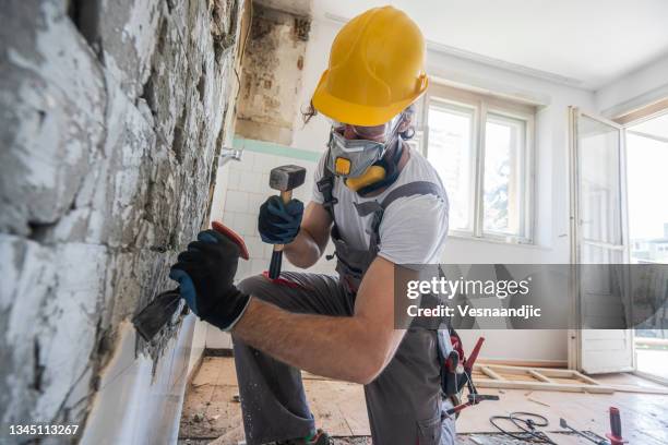worker using hammer - demolishing stock pictures, royalty-free photos & images