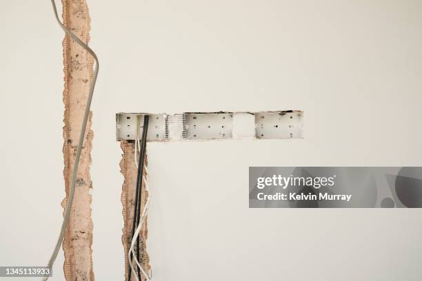 a female builder stands in a half finished room on a building site. she looks at camera - femalefocuscollection stock pictures, royalty-free photos & images