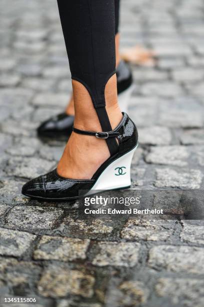 Stavroula Sitoura wears black pants, black shiny leather pointed with white wedge heels shoes from Chanel, outside Chanel, during Paris Fashion Week...