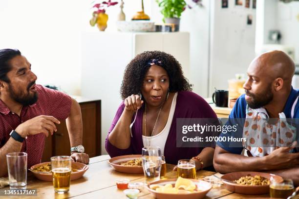 three friends smiling and talking over dinner - licking lips stock pictures, royalty-free photos & images