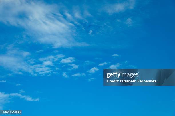 white clouds on blue sky. cirrus fibratus and cirrocumulus clouds. - cirrocúmulo fotografías e imágenes de stock