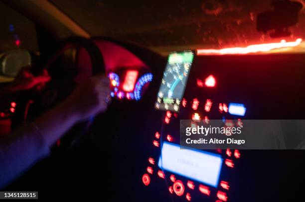 moving image of a car driving at night with a gbps on a mobile phone. - drunk driving crash stock pictures, royalty-free photos & images