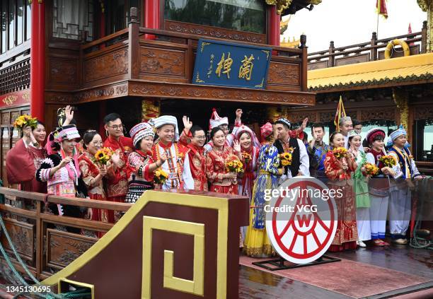 Newly-wed couples attend a group wedding ceremony at the West Lake during Chinese National Day holiday on October 6, 2021 in Hangzhou, Zhejiang...