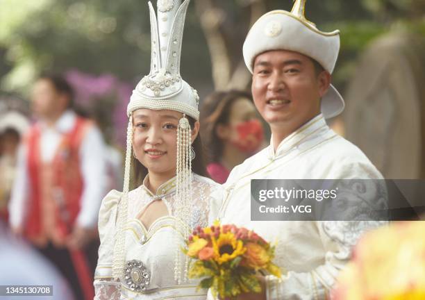 Newly-wed couple attend a group wedding ceremony at the West Lake during Chinese National Day holiday on October 6, 2021 in Hangzhou, Zhejiang...