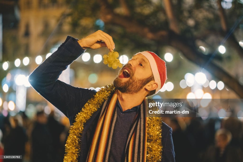 Man eating grape at New Year's eve in Spain