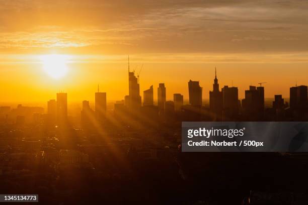 view of buildings in city during sunset,warsaw,poland - warsaw panorama stock pictures, royalty-free photos & images