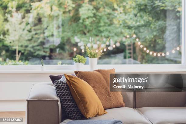 pillows on a couch in the living room. decoration service at a garden party, summer festival, or wedding. catering. - party wohnzimmer stock-fotos und bilder