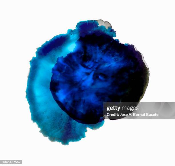 splashes of a drop of blue paint on a white canvas. - ink stock pictures, royalty-free photos & images