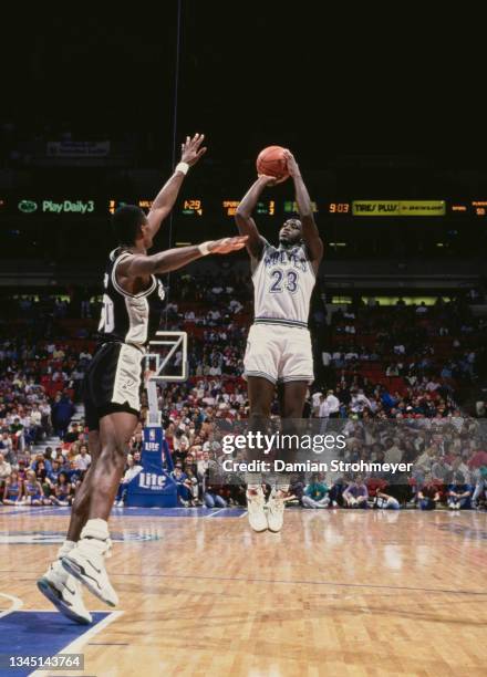 Tyrone Corbin, Small Forward for the Minnesota Timberwolves prepares to make a jump shot to the basket as David Robinson of the San Antonio Spurs...