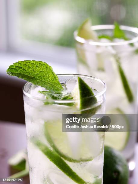 close-up of drink on table - a vodka soda with lime stock pictures, royalty-free photos & images