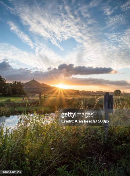 scenic view of field against sky during sunset,glastonbury tor,glastonbury,united kingdom,uk - somerset   england stock pictures, royalty-free photos & images