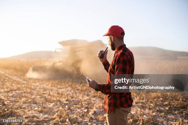 farmer development harvesting on agriculture field.. - walkie talkie stock pictures, royalty-free photos & images