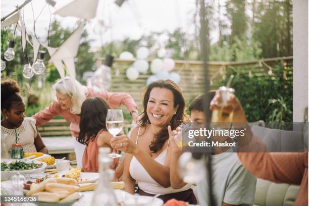 smiling family members having drinks in birthday party - older woman birthday stock pictures, royalty-free photos & images