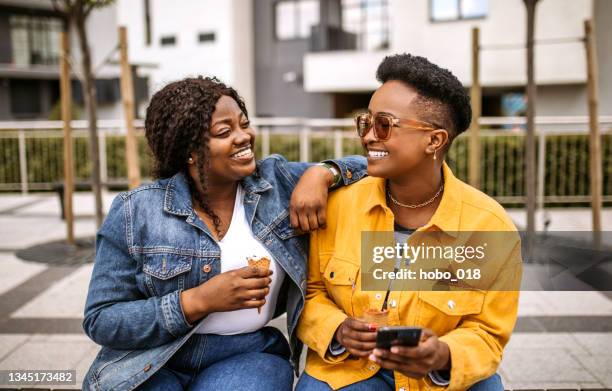 hanging out on a sunny autumn day - chubby black women stock pictures, royalty-free photos & images