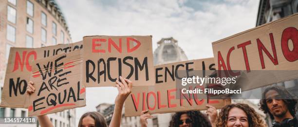 people are marching on strike against racism - public demonstration stock pictures, royalty-free photos & images