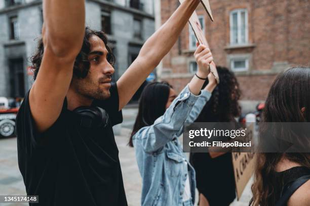 protest of people against racism - male protestor stock pictures, royalty-free photos & images