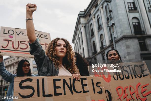 protest of people against racism - fist raised stock pictures, royalty-free photos & images