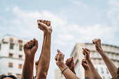 People with raised fists at a demonstration in the city