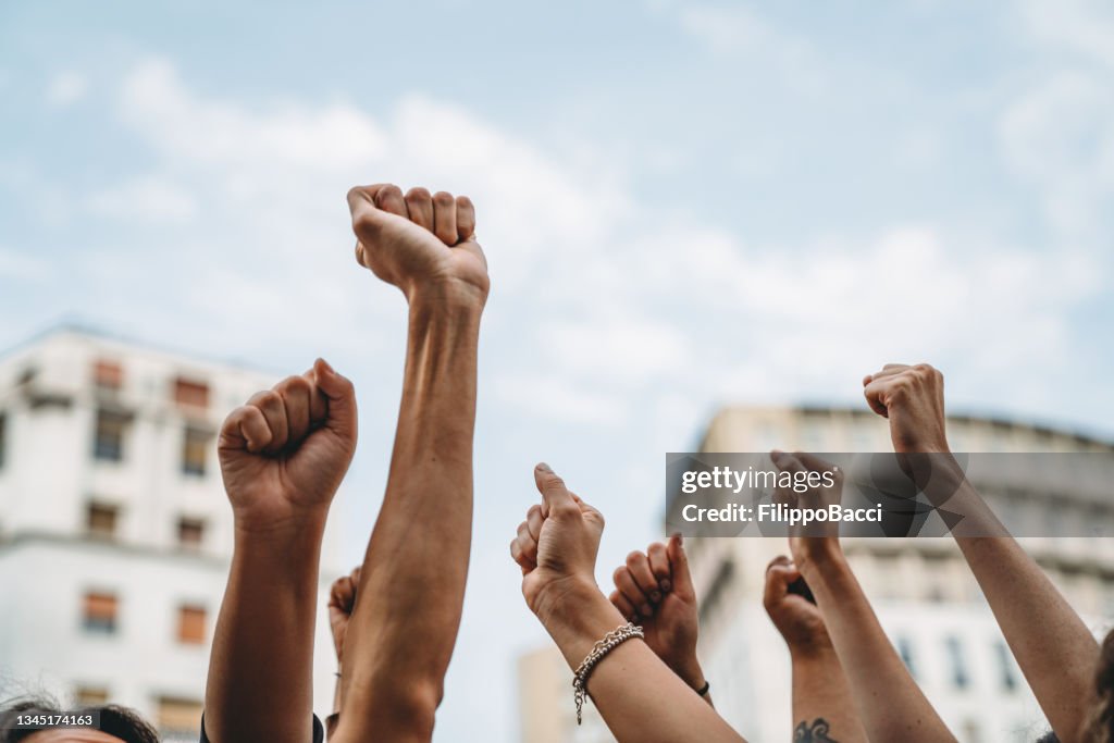 People with raised fists at a demonstration in the city