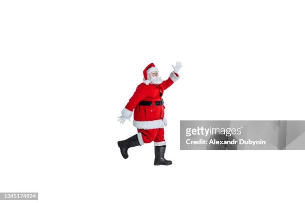 happy santa claus jumping for joy on white background isolate. concept for christmas and new year gifts and sale - happy santa claus over white blank stockfoto's en -beelden