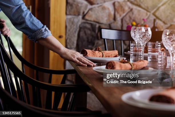 mature woman arranging dinner table at home - table setting stock pictures, royalty-free photos & images