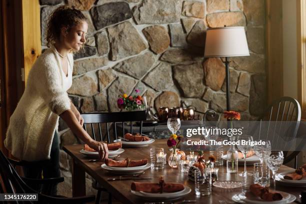 teenage girl setting table in dining room at home - テーブルコーディネート ストックフォトと画像