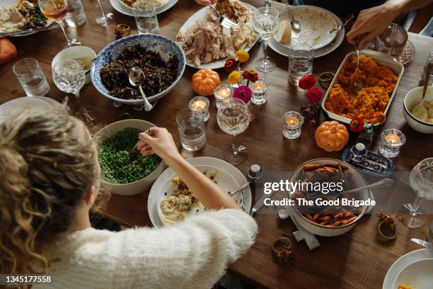 teenage girl having food while sitting at dining table during thanksgiving - dinner fotografías e imágenes de stock