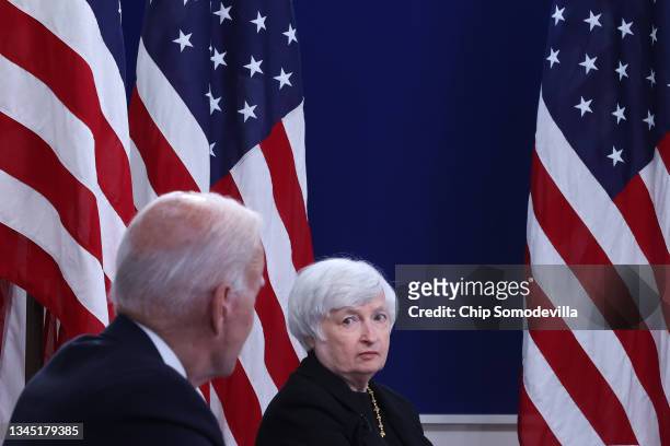 Treasury Secretary Janet Yellen listens to President Joe Biden during a hybrid meeting with corporate chief executives and members of his cabinet to...