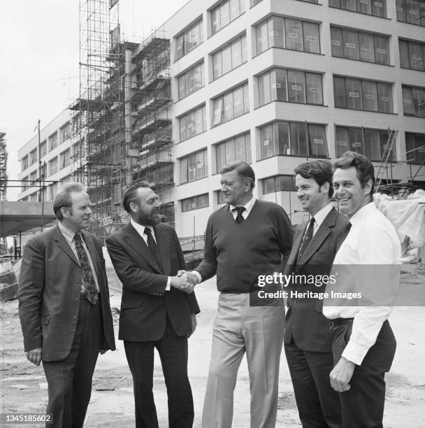 The actor John Wayne meeting staff working at the St Thomas' Hospital construction site. This photograph was taken during the filming of Brannigan,...