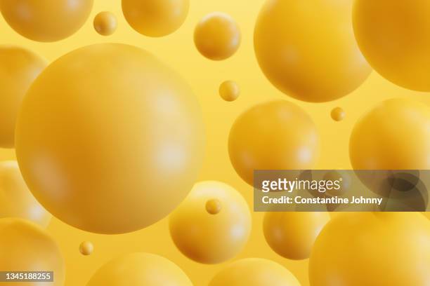 abstract group of geometric spheres yellow background - yellow background stock-fotos und bilder