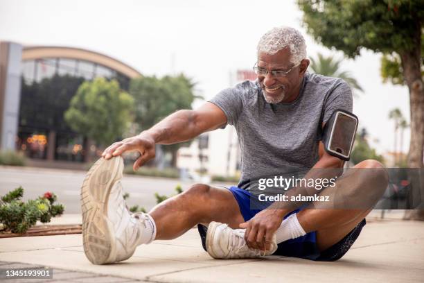 senior black couple exercising in the city - hamstring stock pictures, royalty-free photos & images