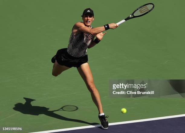 Andrea Petkovic of Germany plays a forehand against Yulia Putintseva of Kazakhstan during their first round match on Day 3 of the BNP Paribas Open at...
