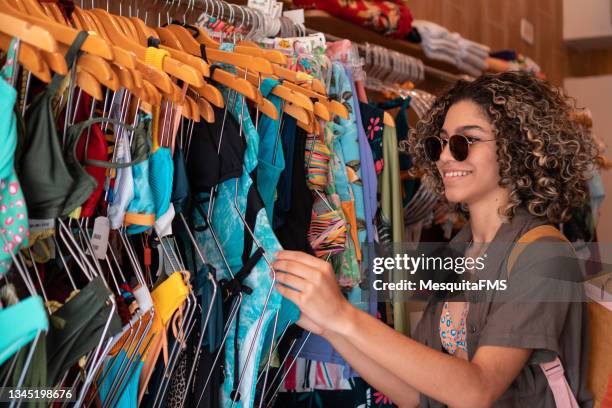 teenager choosing bikini in store - swimwear stock pictures, royalty-free photos & images