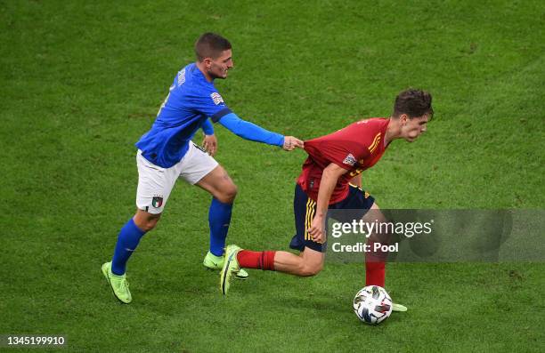 Gavi of Spain is held back by Marco Verratti of Italy during the UEFA Nations League 2021 Semi-final match between Italy and Spain at San Siro...