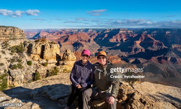 senior couple taking a selfie on the south rim of the grand canyon - couple grand canyon stock pictures, royalty-free photos & images