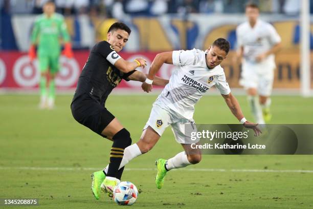 Eduard Atuesta of Los Angeles FC and Javier Hernandez of Los Angeles Galaxy fight for control of the ball during the second half of a game at Dignity...