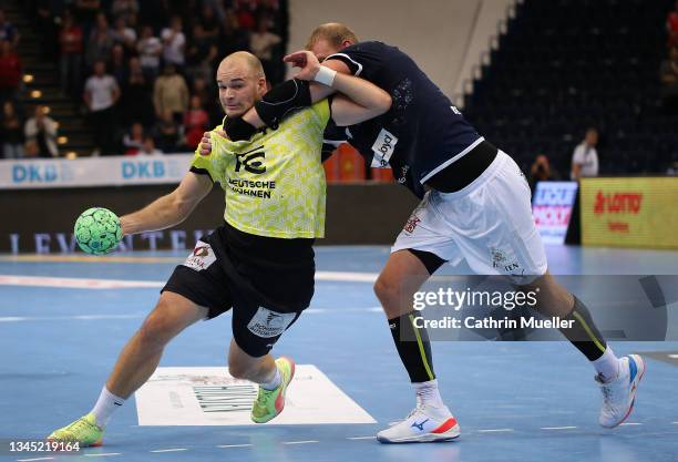 Paul Drux of Fuechse Berlin is challenged by Manuel Spaeth of Handball Sport Verein Hamburg during the DHB-Pokal match between Handball Sport Verein...