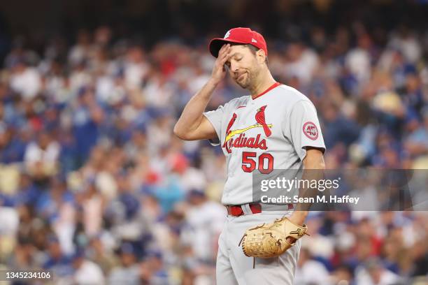 Adam Wainwright of the St. Louis Cardinals reacts after walking Cody Bellinger of the Los Angeles Dodgers in the third inning during the National...