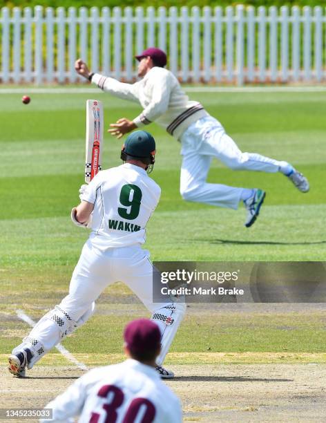 Charlie Wakim of the Tasmanian Tigers hits and is dropped at square leg by Jack Wildermuth of the Queensland Bulls during day one of the Sheffield...