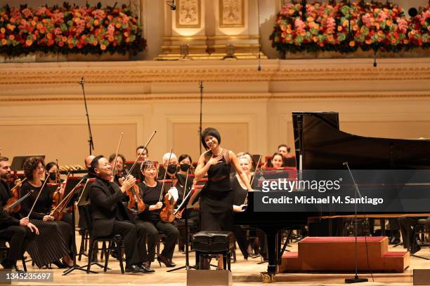 Pianist Yuja Wang greets audience members as she prepares to perform with the Philadelphia Orchestra during opening night at the Stern Auditorium at...