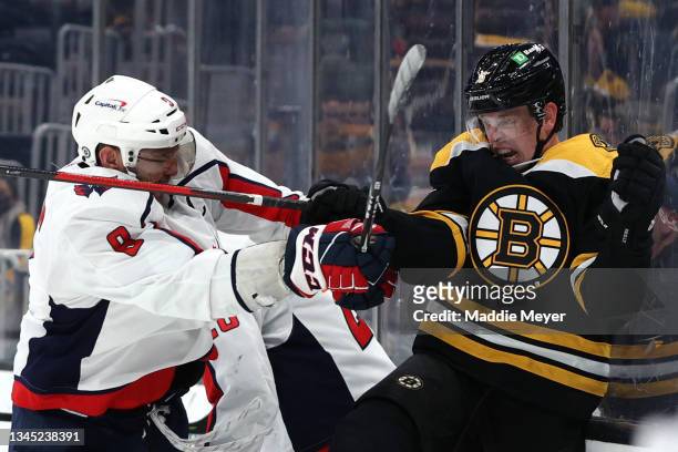 Alex Ovechkin of the Washington Capitals shoves Mike Reilly of the Boston Bruins into the boards during the third period of the preseason game at TD...